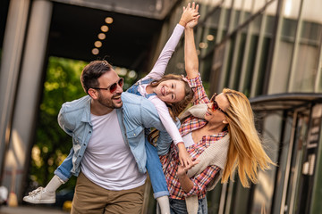 Happy smiling family with daughter outdoors