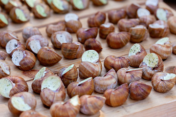 Cooked snails delicacy. French cuisine stuffed snails. Street food festival