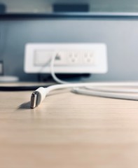 Phone cable connected to blurred outlet