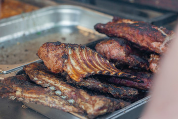 Grilled pork ribs on the grill at street food festival