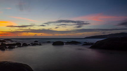 Fototapeta na wymiar Long exposure picture of colorful sunset at Kamala beach in Thailand in summer