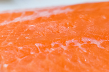 Pulling tweezers of small bones from piece of red fish.