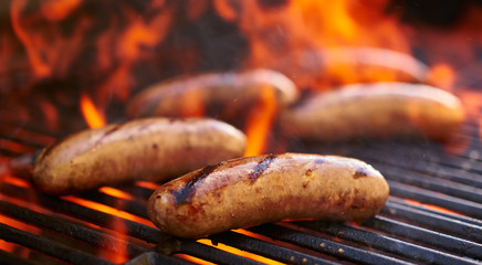 Fototapeta tasty bratwurst sausage barbecuing on the grill obraz