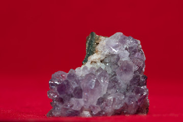 crystal geode rock purple blue on red background