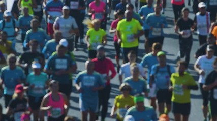 Blurry close up shot of marathon runners jogging