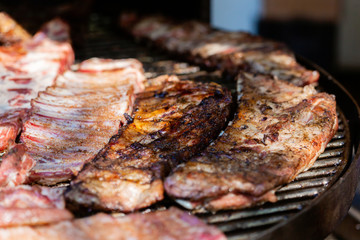 Grilled pork ribs on the grill at street food festival