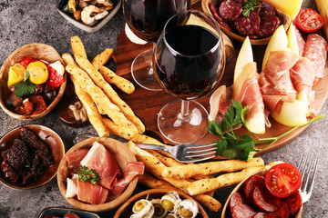Italian antipasti wine snacks set. Cheese variety, Mediterranean olives, seafood salad, Prosciutto...