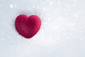 Red heart in sparkling snow. Valentines day concept