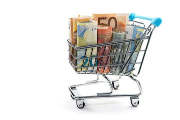 Closeup of a shopping cart full of euro banknotes isolated on white. concept: loan, investment, pension, saving money, financing, collateral, debt, mortgage, financial crisis or rise