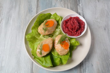Traditional Jewish Passover food- gefilte fish with carrots, lettuce and horseradish. Rosh Hashana table setting