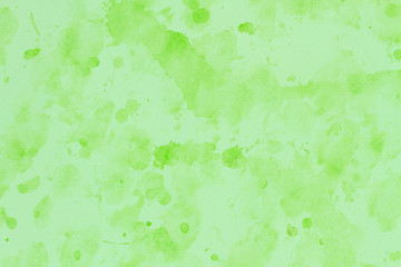 green stroke of the paint brush on white paper