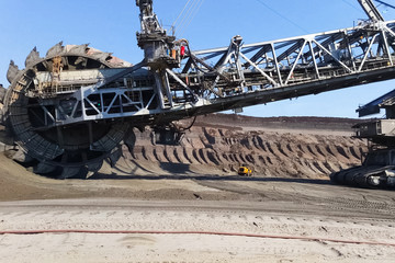 Fototapeta premium work of a bucket wheel excavator in a quarry. Ore mining in a quarry.