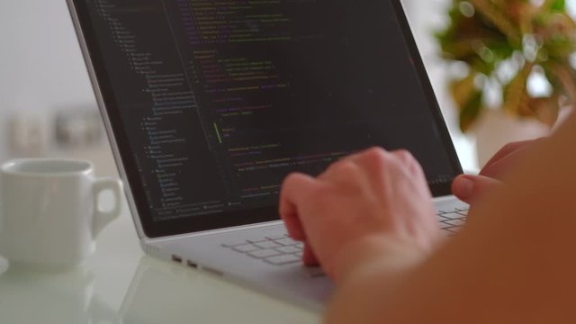 Man typying on laptop, close up software development