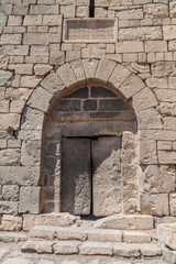 Fototapeta na wymiar Stone door of Qasr al-Azraq (Blue Fortress), fortress located in the desert of eastern Jordan.
