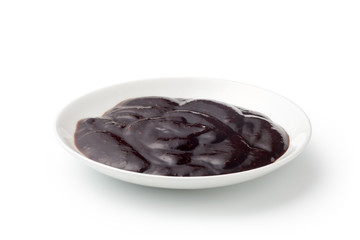 Black pepper sauce in a ceramics plate isolated on white background