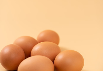 Close-up of eggs placed in front of yellow background