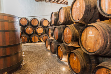 VILA NOVA DE GAIA, PORTUGAL - OCTOBER 18, 2017: Barrels of Port wine at Ramos Pinto winery cellar...