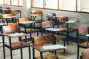 selective soft and blur focus.old wooden row lecture chairs in dirty classroom in poor school.study...