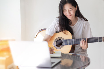 artist songwriter thinking writing notes,lyrics in book at studio.man playing live acoustic guitar relax chill.concept for musician creative.composer work process.people relaxing time with instrument