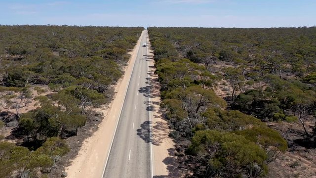 Smooth 4K drone footage of of the long straight road that is the Eyre Highway, crossing the Nullarbor Plain in South Australia