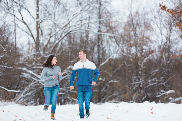 Fototapeta na wymiar Love Valentine Concept. people, season, love and leisure concept. happy couple walking through the park on a snowy day. Romantic couple in love feeling happiness romance Valentine . love copy space.