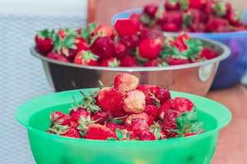 Beautiful fresh strawberries in plastic containers stands on the table