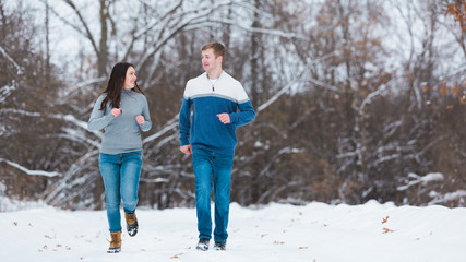 Love Valentine Concept. people, season, love and leisure concept. happy couple walking through the park on a snowy day. Romantic couple in love feeling happiness romance Valentine . love copy space.