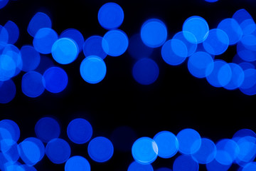 Defocused of blurred phantom blue bokeh circle light from lighting bulb in the dark night for abstract background texture patterns