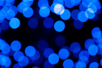 Defocused of blurred phantom blue bokeh circle light from lighting bulb in the dark night for abstract background texture patterns