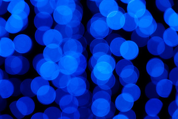 Defocused of blurred phantom blue bokeh circle light from lighting bulb in the dark night for abstract background texture patterns