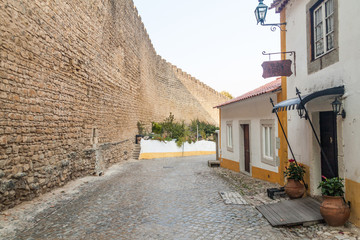 Dom Joao de Ornelas street next to the fortification walls of Obidos village, Portugal