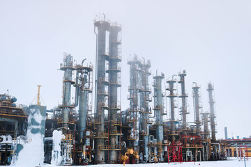 Iron metal industrial plant installations with stairs, fences and pipes, distillation columns at the oil refining chemical metallurgical construction plant