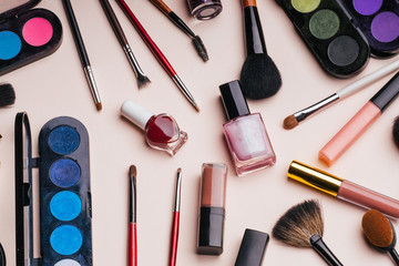 set of female cosmetics for eye makeup, skin face care. Professional products for beauty on a pink background