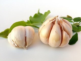 garlic and green leaf isolated on white background