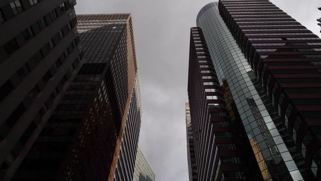 Low angle aerial drone shot of modern skyscrapers in New York City Manhattan. NYC business offices, apartments & shops, American modern urban life.