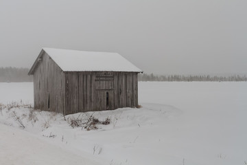 Old Barn House In The Snow Storm