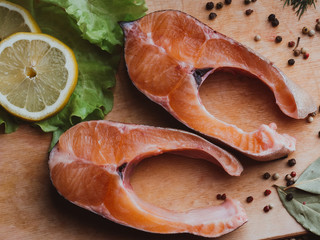 sliced pieces of fresh raw trout on Board. Red fish fillet