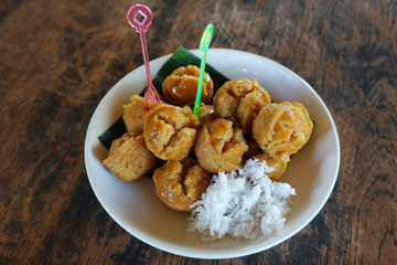 Thai dessert close up in ceramic cup on wooden table