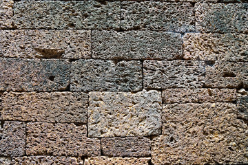 background, wall of volcanic brown old brick, porous relief surface, texture