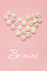 Valentines day card in pink pastel color - heart made of meringue and text BE MINE