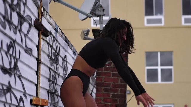 Fit young sexy hispanic woman dancing. Concept of urban dancer lifestyle, millenial creative arts in NYC, mixed race American girl. Slow motion. 