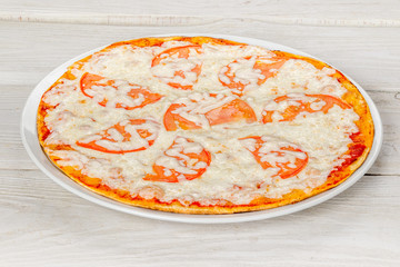 Margarita pizza with tomatoes and cheese closeup shot