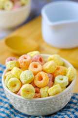 Cereal flakes in white bowl with copy space,Breakfast concept.Food with delicious fruity taste and fruity colours.It's made with maize,wheat,and barley