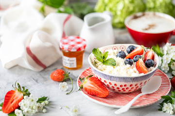 Cottage cheese with berries, jam, fresh strawberries and a cup of coffee with cream for breakfast. The recipe for the holiday Valentine's Day. Copy space