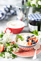 Cottage cheese with berries, jam, fresh strawberries and a cup of coffee with cream for breakfast. The recipe for the holiday Valentine's Day. close-up