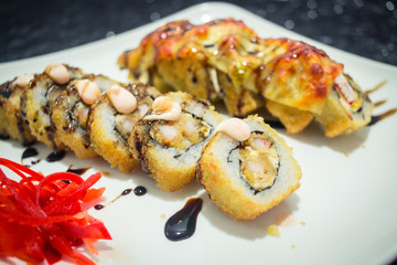 Delicious japanese traditional sushi roll made with rice, eel sauce, crab, shrimp and gratin cheese