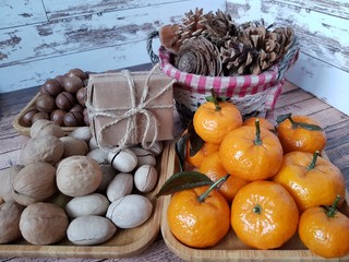 Tangerines, nuts and gifts on the table