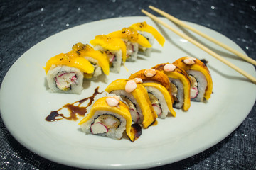 Delicious japanese traditional sushi roll made with rice, eel sauce, crab, shrimp and plantain