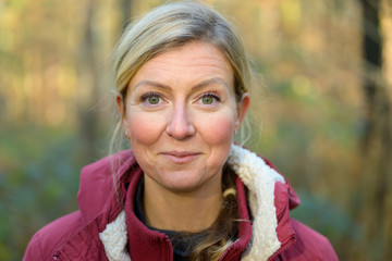 Adult woman in red jacket smiling at camera