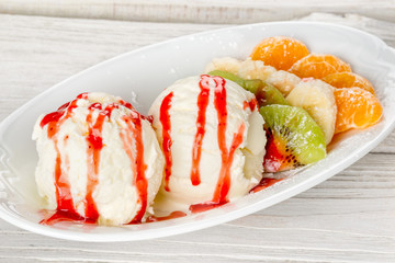 Ice cream in a glass bowl shot on a wooden white background